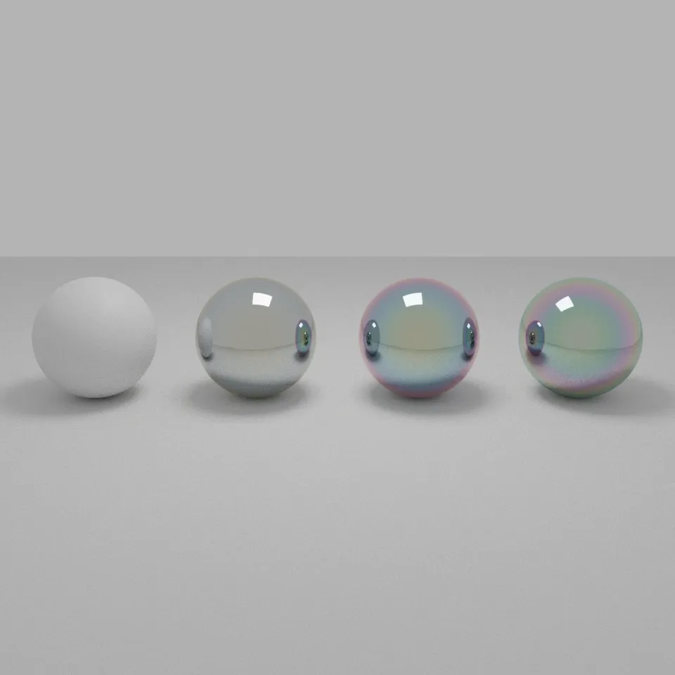 Four glossy spheres in a row, each with a different soap-bubble colour from increasing thin-film thickness